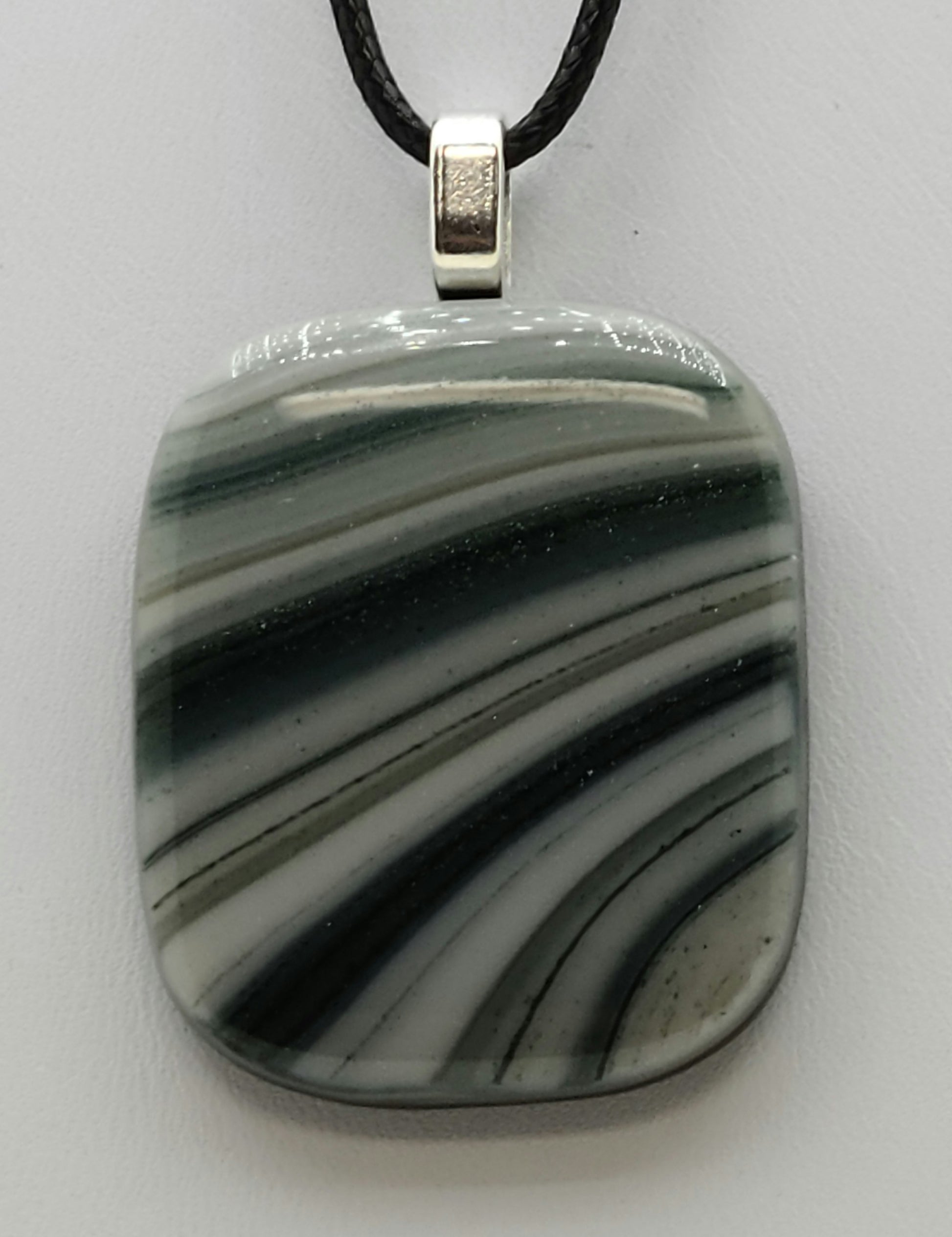 glittery green sweeps across this fused glass pendant.
