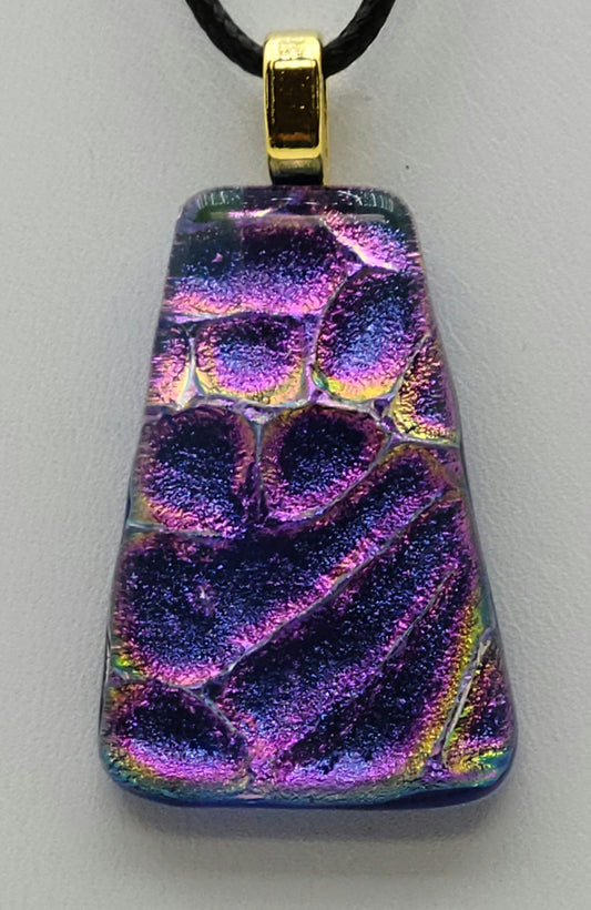 This lovely dichroic fused glass pendant is bluish purple with hints of gold & fuchsia.