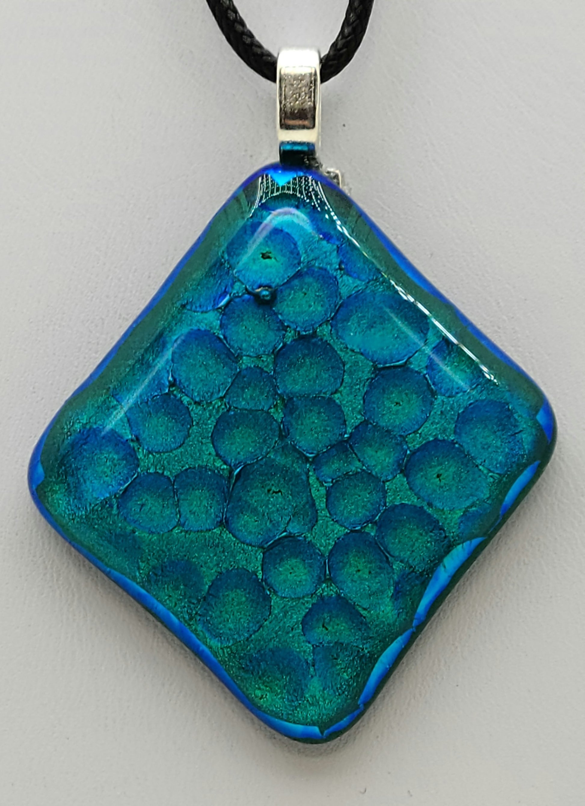 This dichroic fused glass pendant looks like the waters of the Caribbean!
