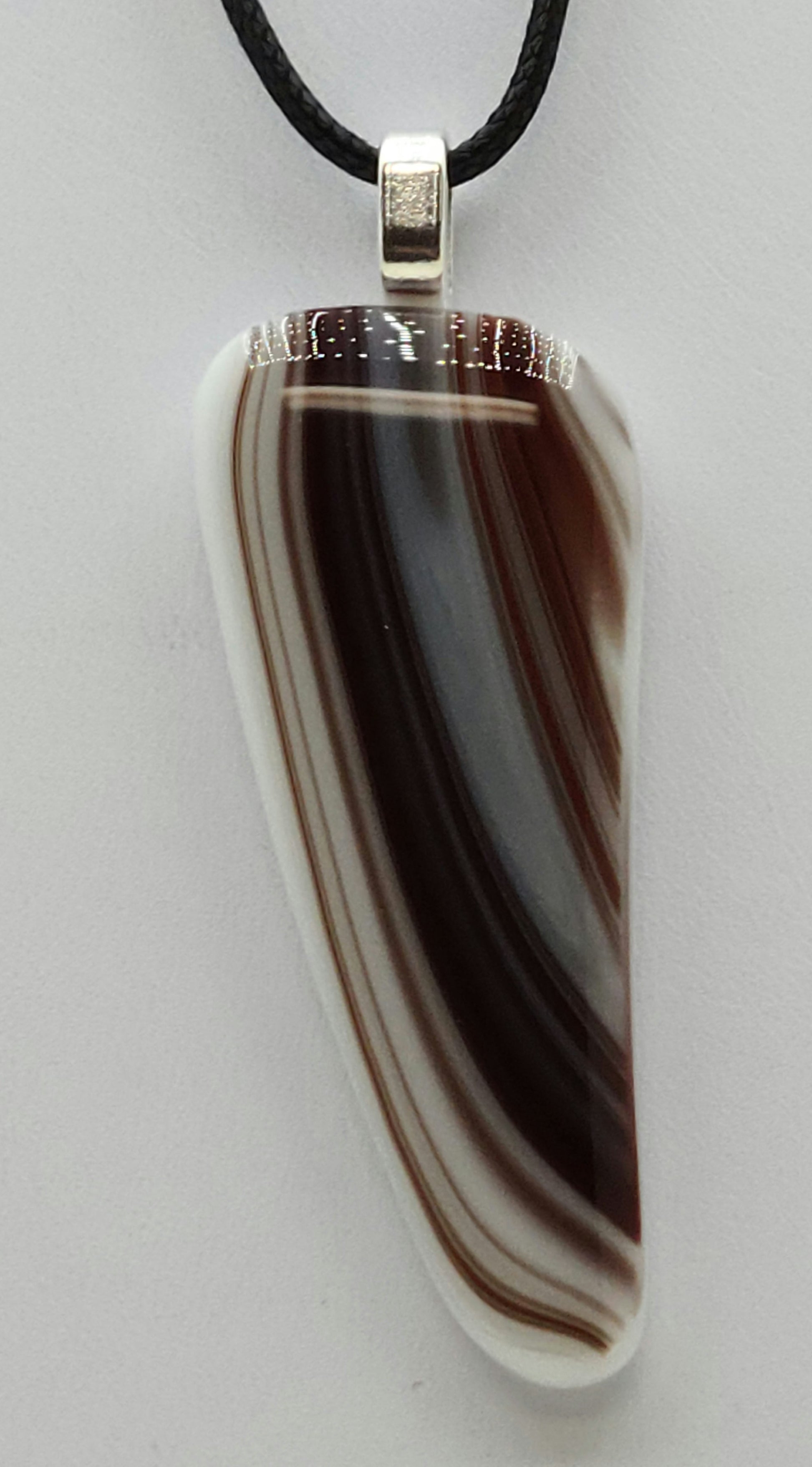deep red sweeps adorn this 'tooth' fused glass pendant.
