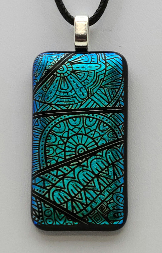 modern free-style designs adorn this blue green dichroic fused glass pendant.