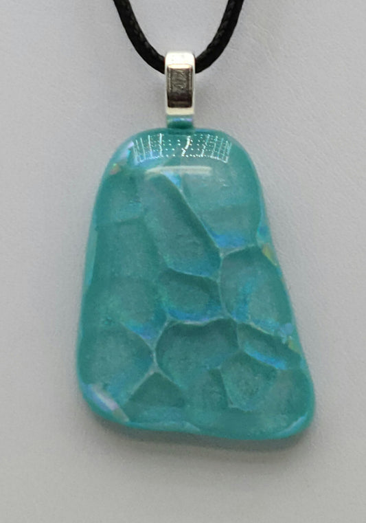 Float in calm Caribbean waters with this dichroic fused glass pendant.