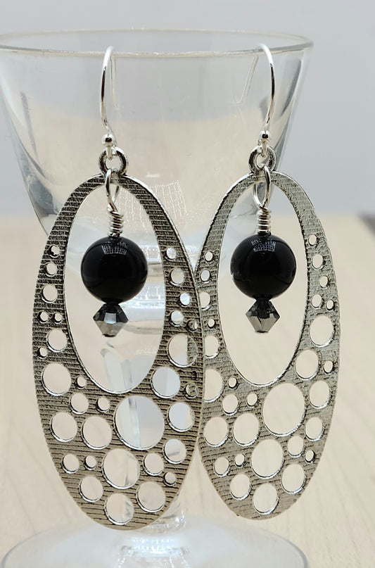 These pewter oval 'holey' hoops are such fun! Black crystal pearls with chrome crystal accents add color &amp; movement!