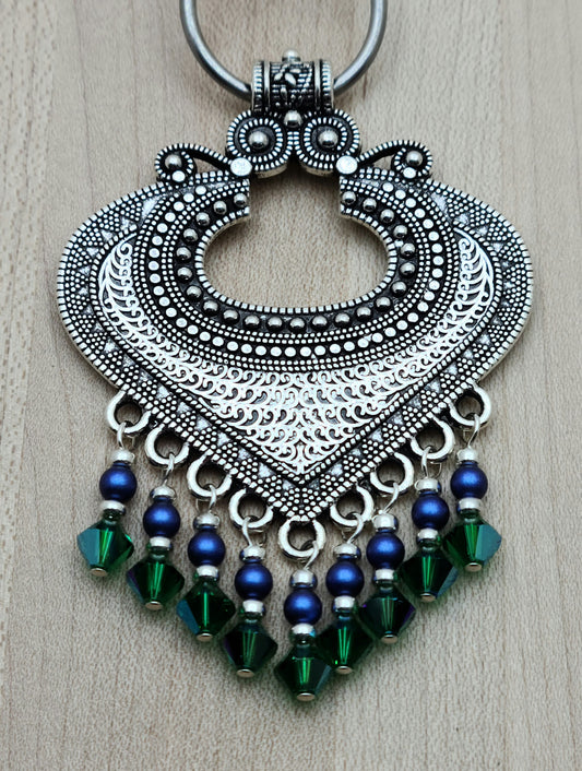 large pewter bali style pendant with bright blue and rich green dangles 
