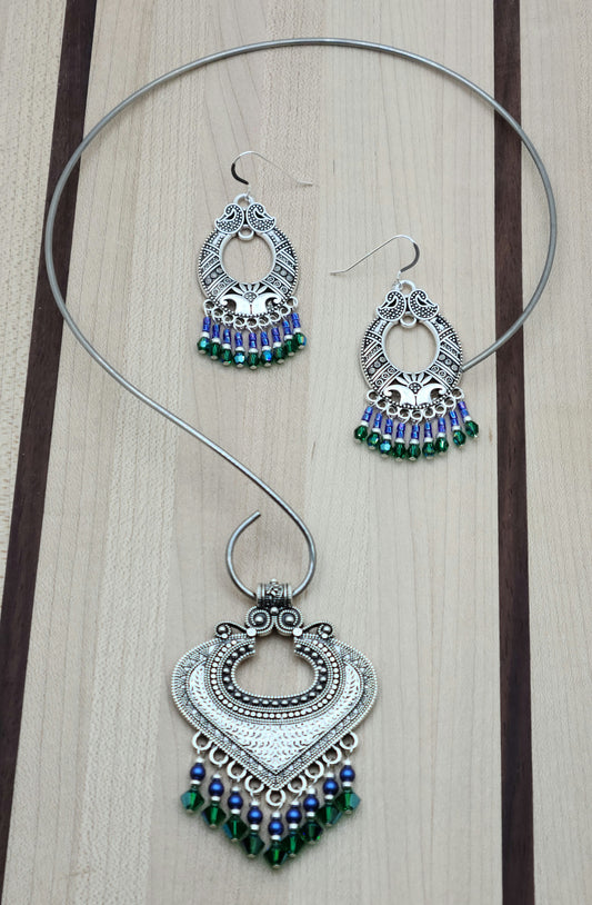 large pewter bali style pendant with bright blue and rich green dangles hanging on a stainless steel neck wire
and matching earrings