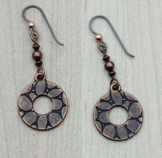 Add a playful spin to your look with these Copper Wheel Earrings. Antique copper beads hold charming embossed ‘wheels’ that sway with every move, bringing a fun, dynamic touch to any outfit.