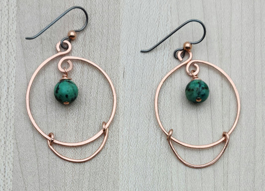 These hammered copper hoops add a playful twist with genuine African turquoise stones, bringing a splash of color to your ears.