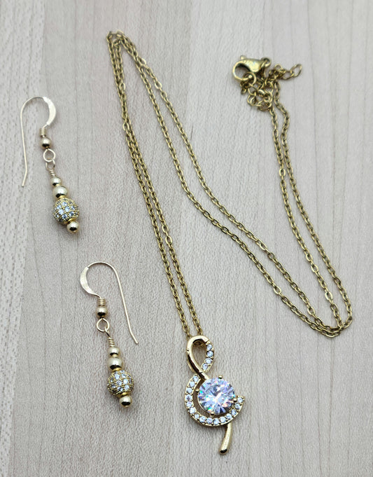 The large cubic zirconia in this gold filled treble clef is definitely an eye-catcher without being 'too much.' It is delicately surrounded by smaller CZ stones & the gold filled fish hook earrings elegantly showcase CZ shamballa beads.