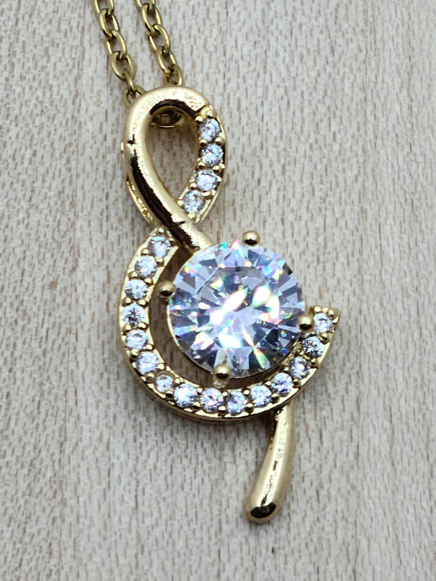 The large cubic zirconia in this gold filled treble clef is definitely an eye-catcher without being 'too much.' It is delicately surrounded by smaller CZ stones.