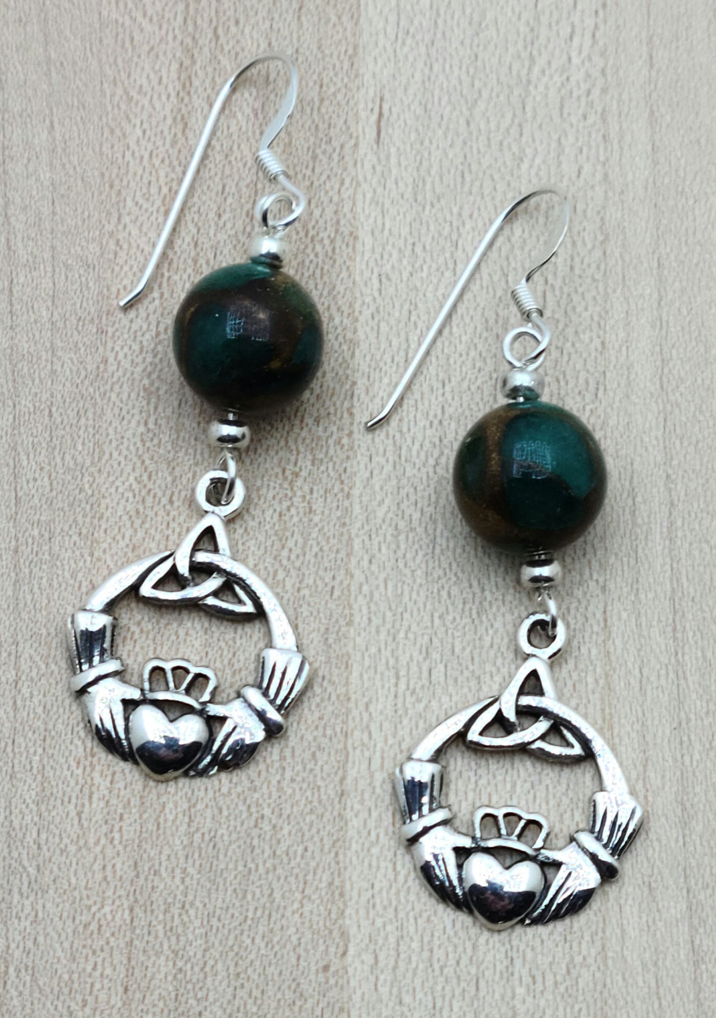 Celtic and the color green seem to just 'click' in these earrings featuring composite malachite stones and sterling silver triquetra and claddagh drops!