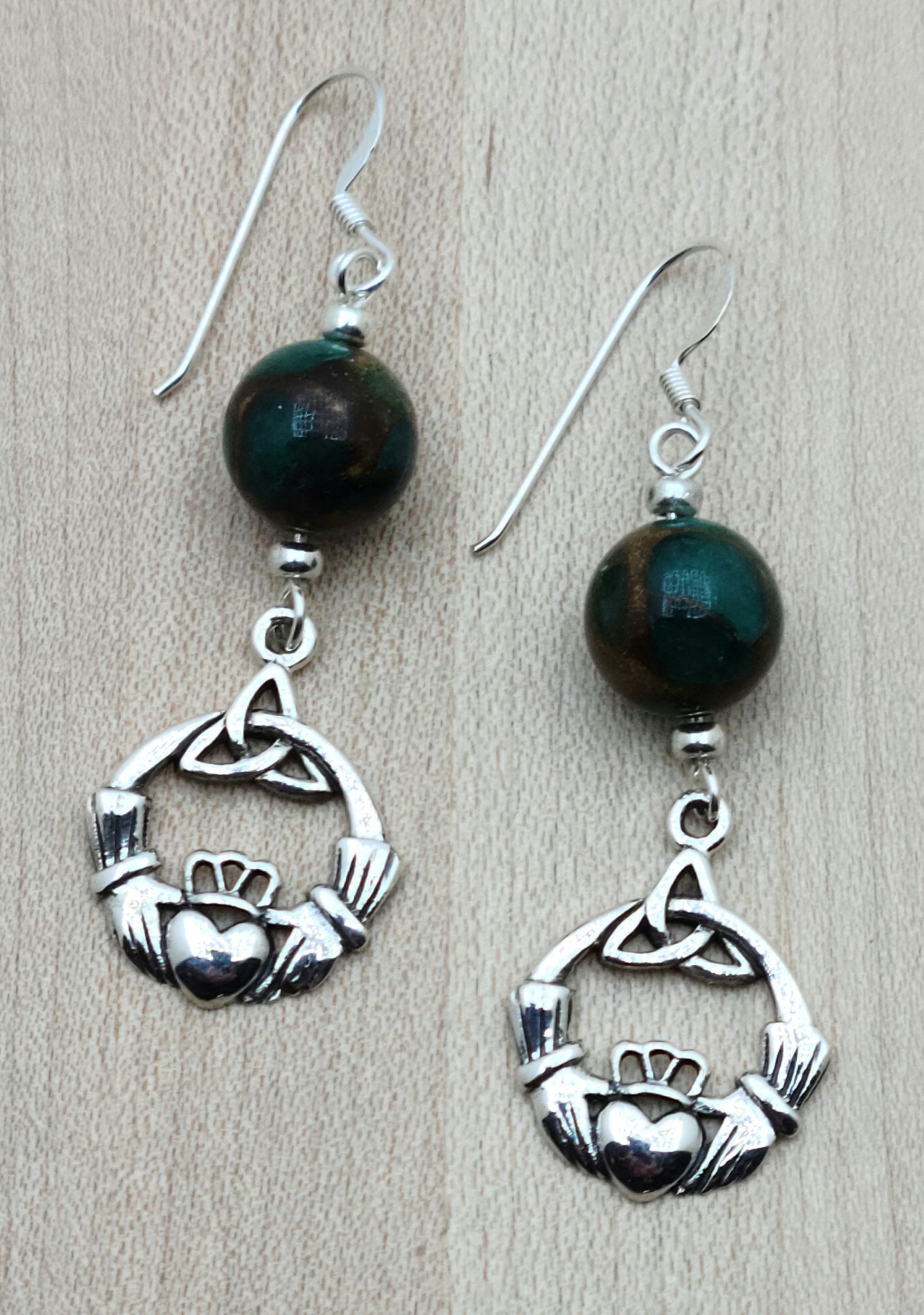 Celtic and the color green seem to just 'click' in these earrings featuring composite malachite stones and sterling silver triquetra and claddagh drops!
