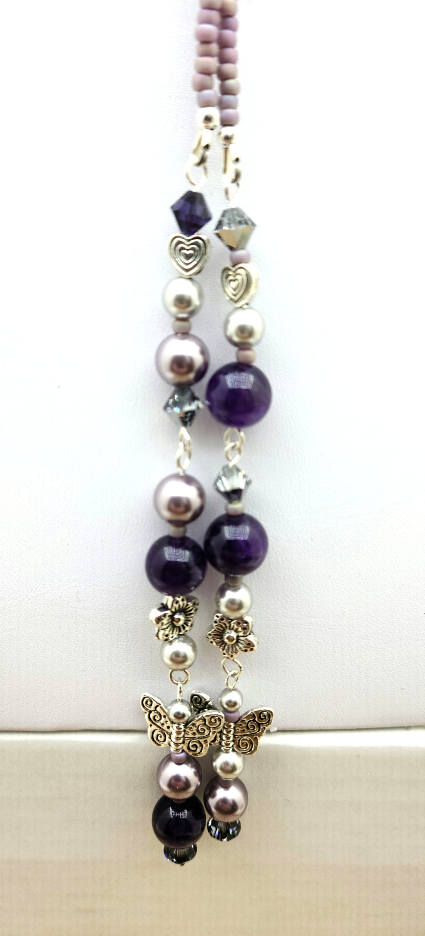 Be your own stylist! Lariat necklaces are such fun! This one features amethyst quartz, pewter butterflies, flowers, & hearts; crystals & crystal pearls; & Miyuki (the best brand) seed beads. There is a lot here to create interest!