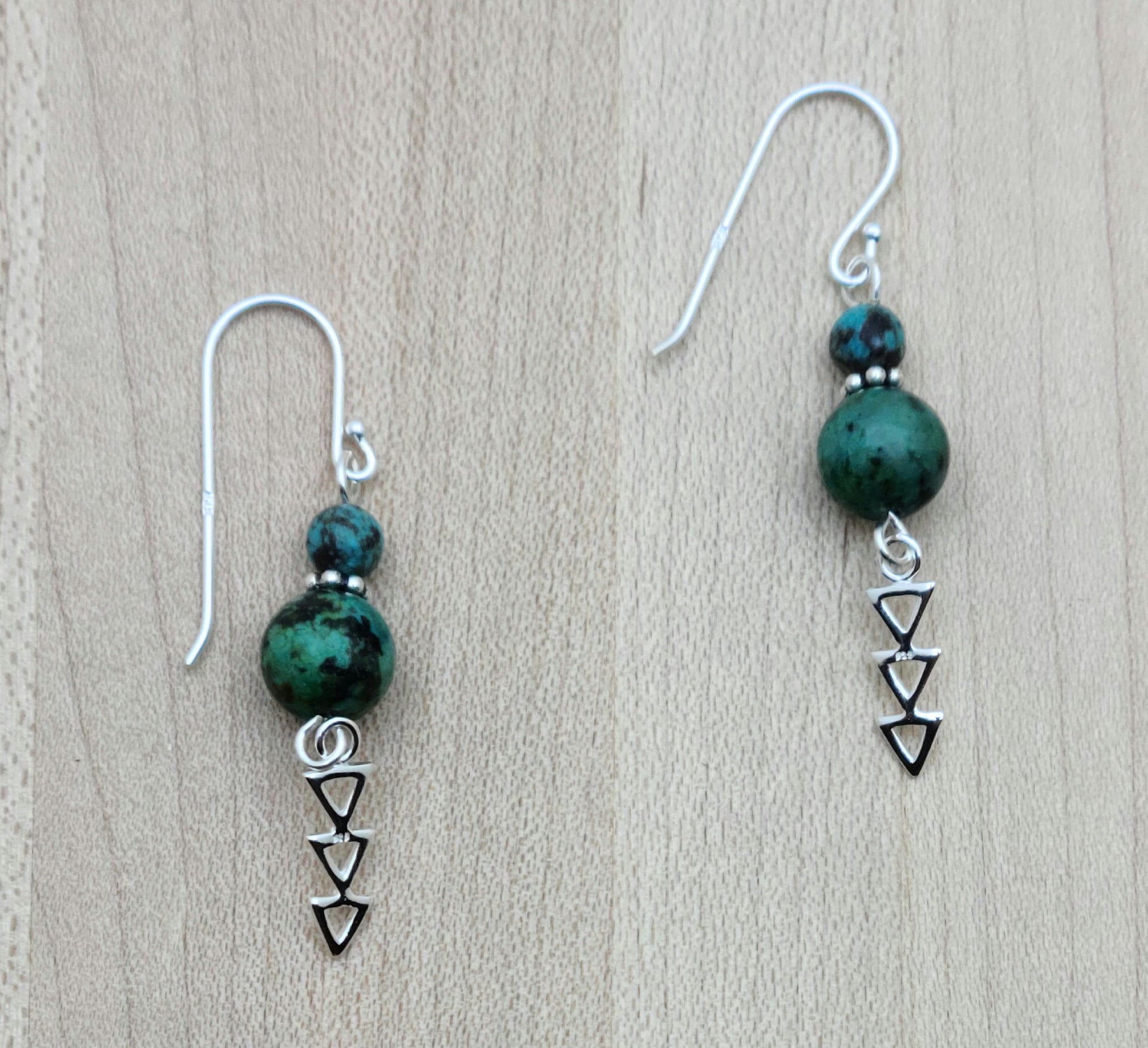 African turquoise beads host dangling  geometric sterling silver designs in these Earrings with sterling silver fish hook ear wires.