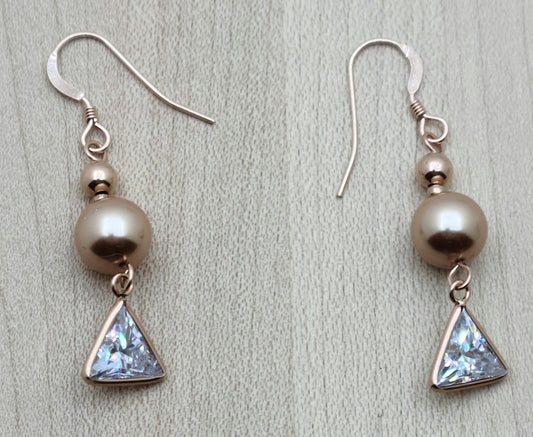 Beautiful rose gold crystal pearls & beads host rose gold bezel framed triangular clear cubic zirconia. Ear wires are rose gold filled fish hooks.