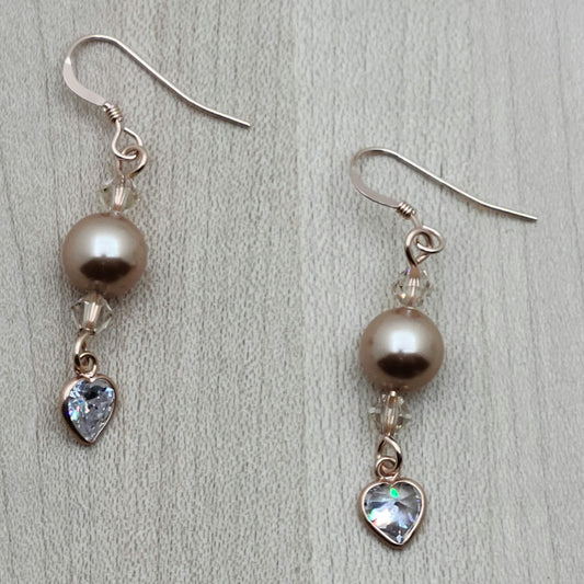 Beautiful rose gold crystal pearls & light silk crystals host brilliant clear cubic zirconia hearts. Very Sweet & Elegant! Ear wires are rose gold filled fish hooks.