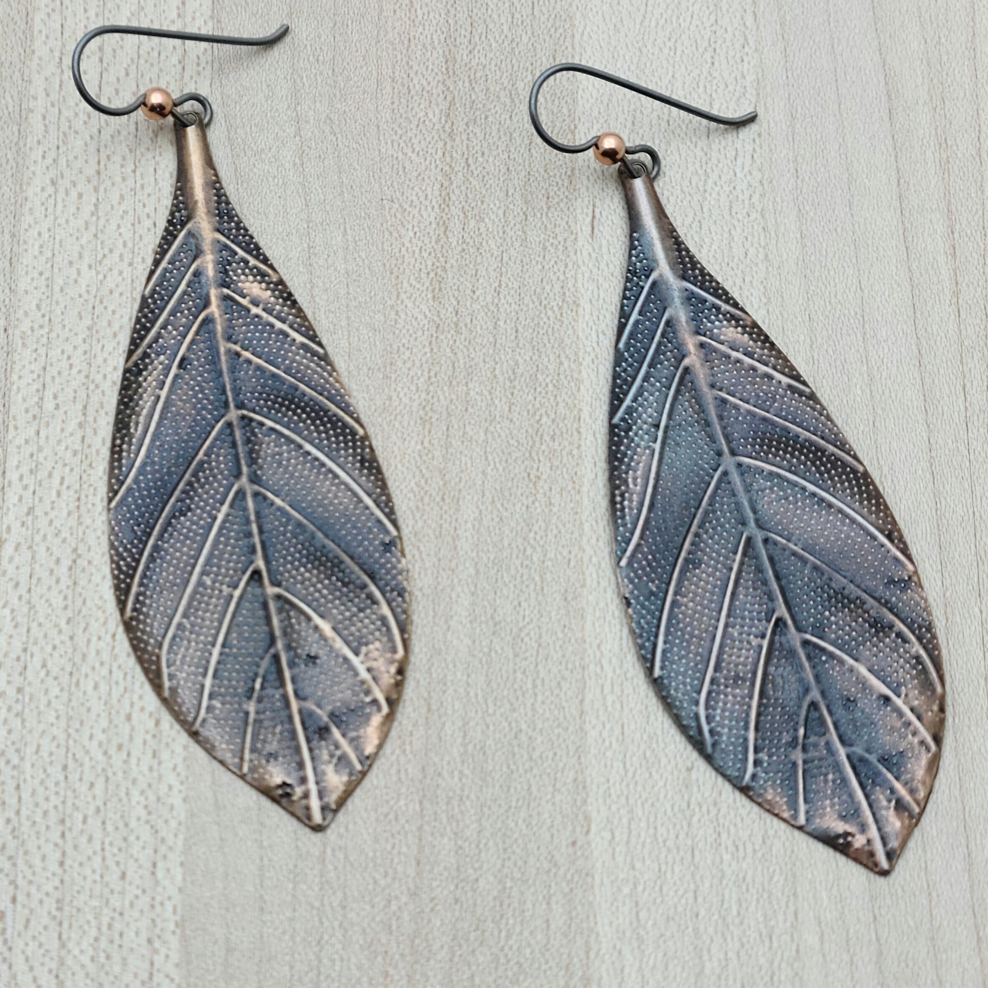 long, lightweight copper leaves suspended from hypoallergenic niobium ear wires