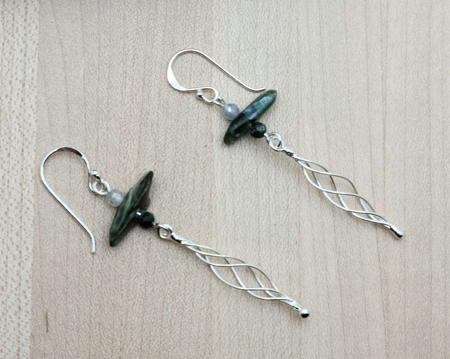 The earrings feature seraphinite & sterling silver twist dangle on sterling silver fish hook ear wires.