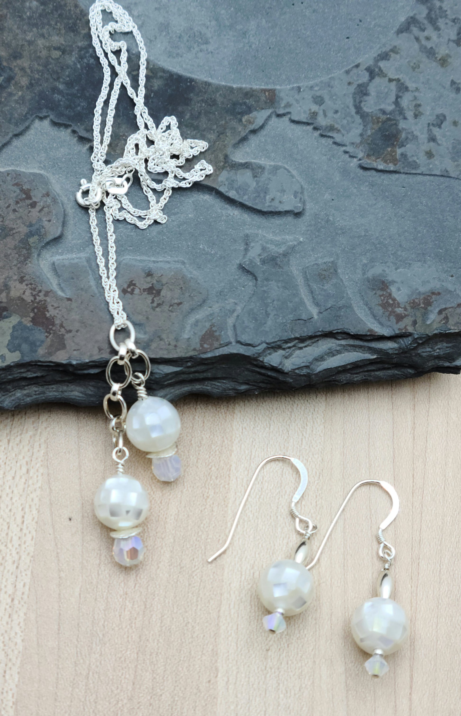 A jewelry set to compliment any outfit! Mosaic styled mother of pearl and white opal crystals dangle elegantly in both necklace & earrings! sterling silver fish hook ear wires