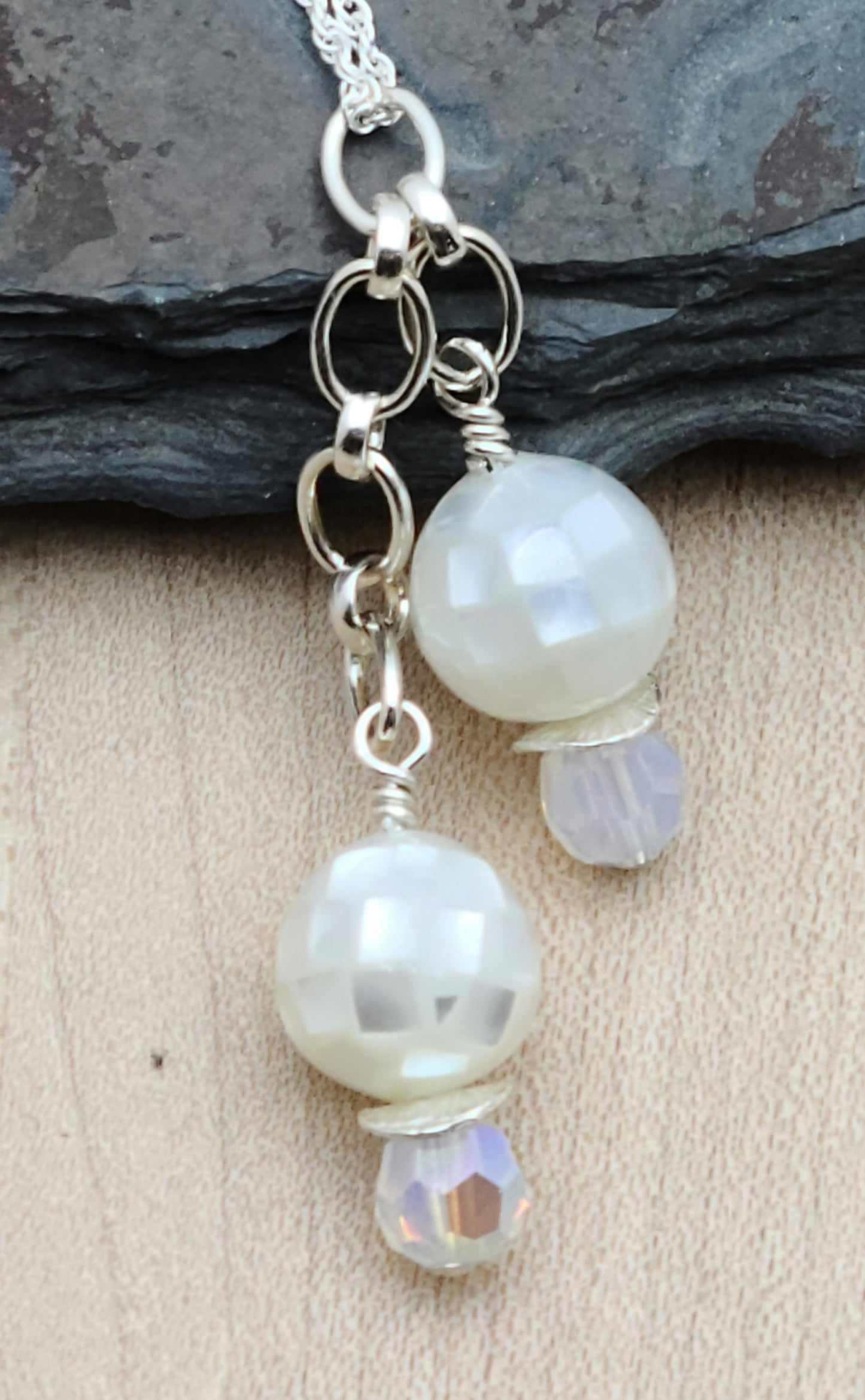  Mosaic styled mother of pearl and white opal crystals dangle elegantly in this necklace