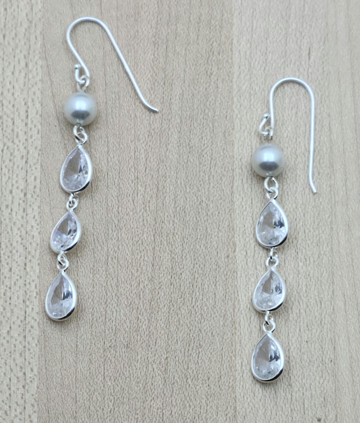 Attract lots of attention with three tiers of cubic zirconia sparkle! Sterling silver fish hook ear wires.