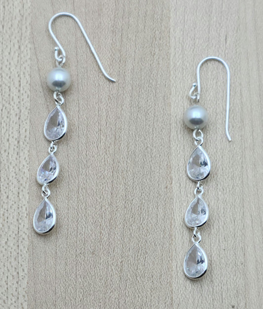 Attract lots of attention with three tiers of cubic zirconia sparkle! Sterling silver fish hook ear wires.