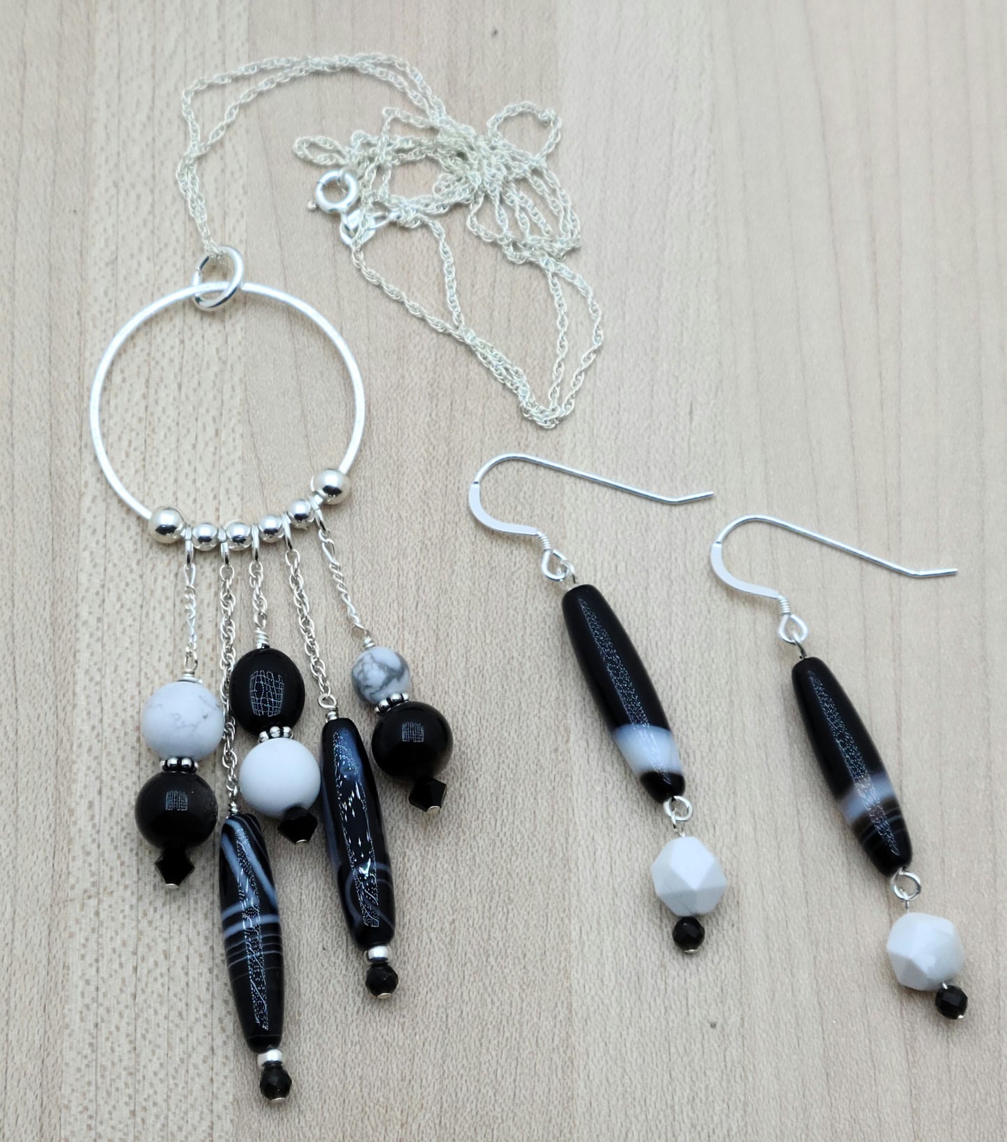 You'll love this eclectic collection of black and white stones and crystals, which dangle casually from a sterling silver hoop. Black & white is a classic combination and will go with almost anything in your wardrobe!