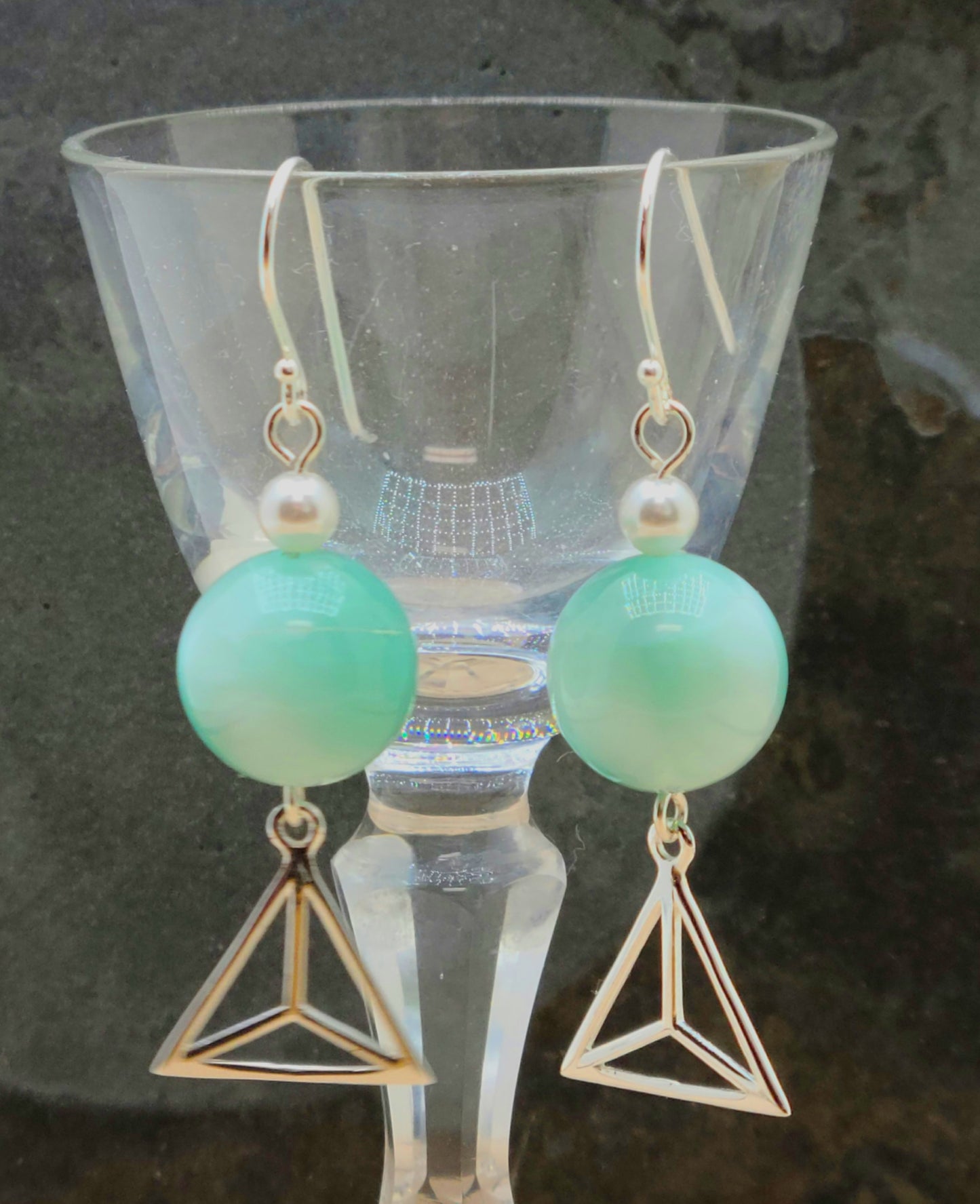 Everyone loves these green angelite stone beads! Accented with white crystal pearls* &  dangling sterling silver geometric charms, these are sure to please!