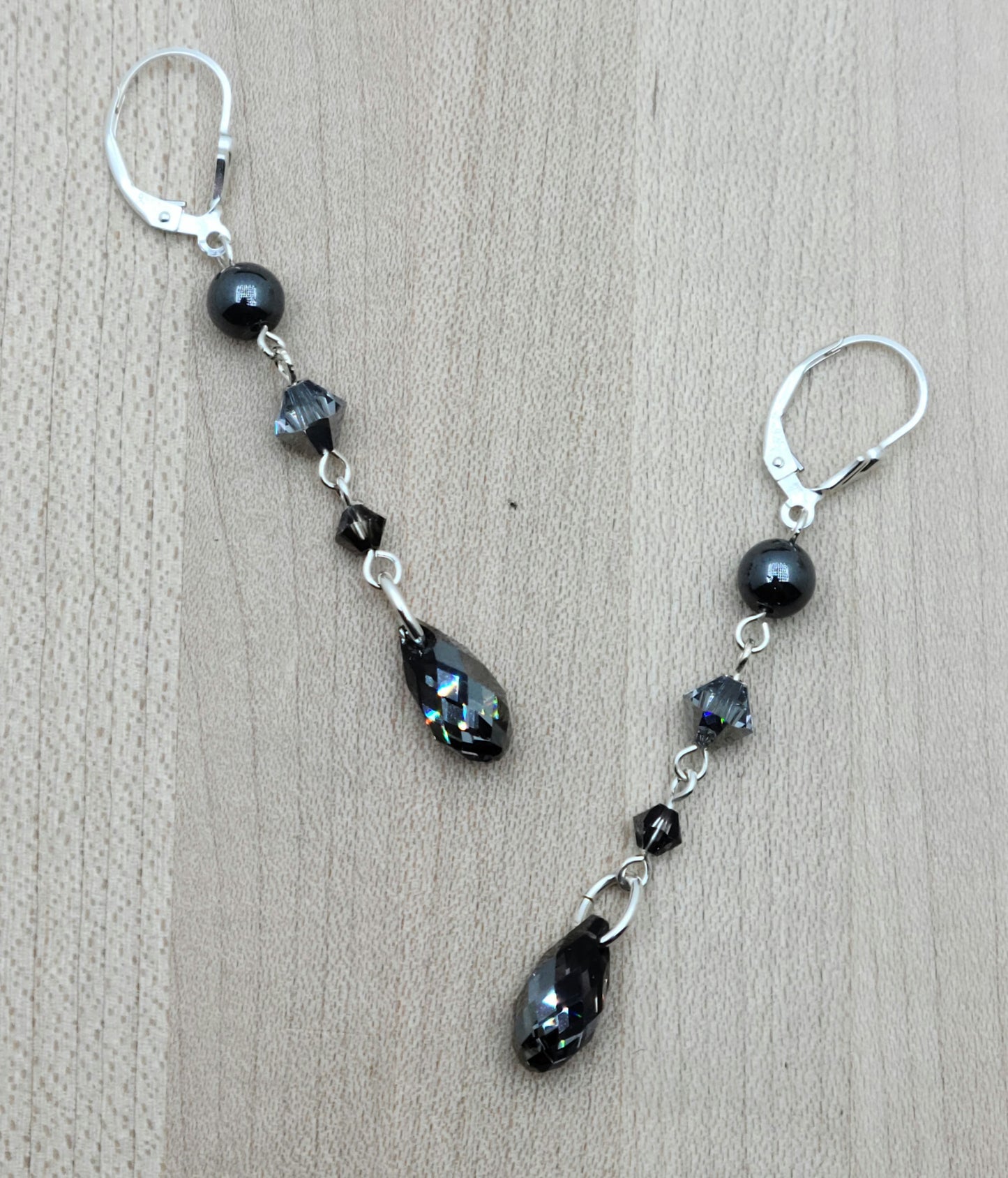 A dramatic look without bulk or weight! A combination of hematite and various shades of black crystals cascade with LOTS of movement!
Sterling silver fish hooks