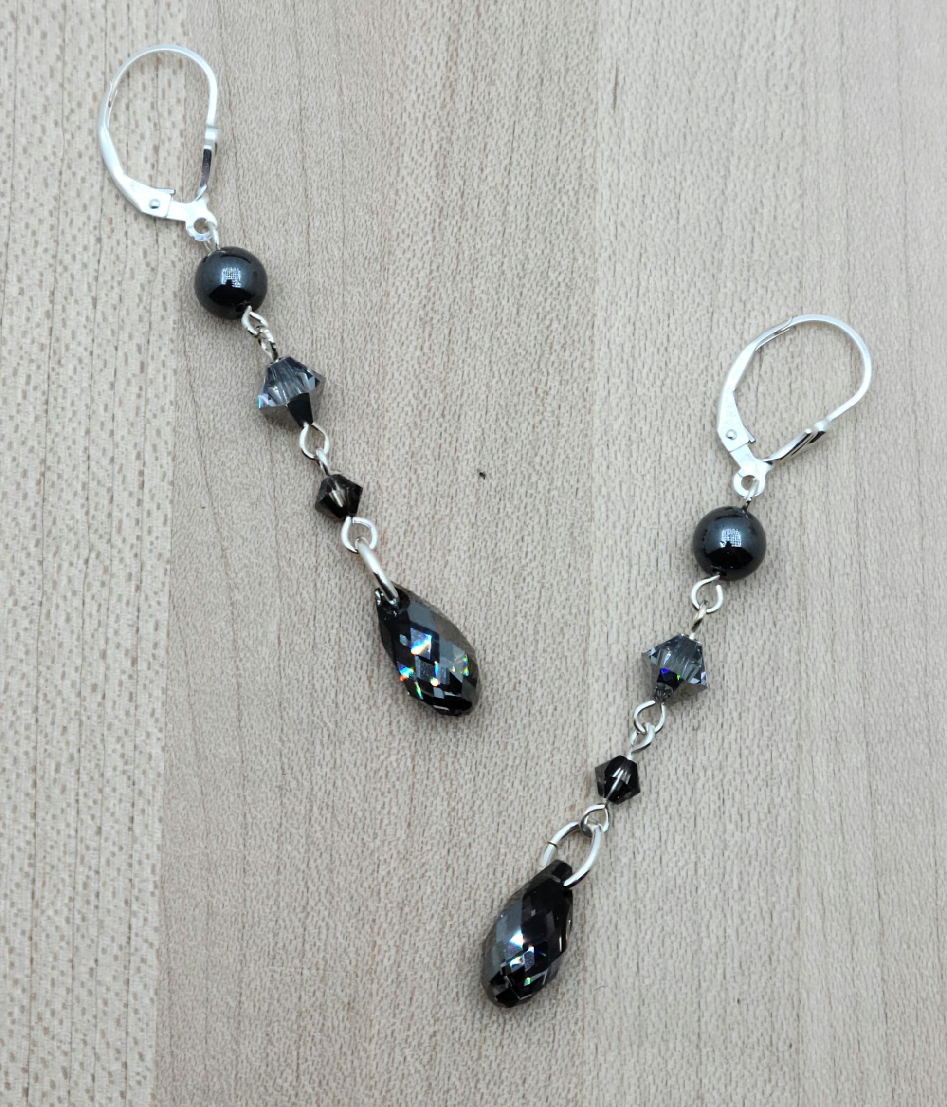 A dramatic look without bulk or weight! A combination of hematite and various shades of black crystals cascade with LOTS of movement!
Sterling silver fish hooks