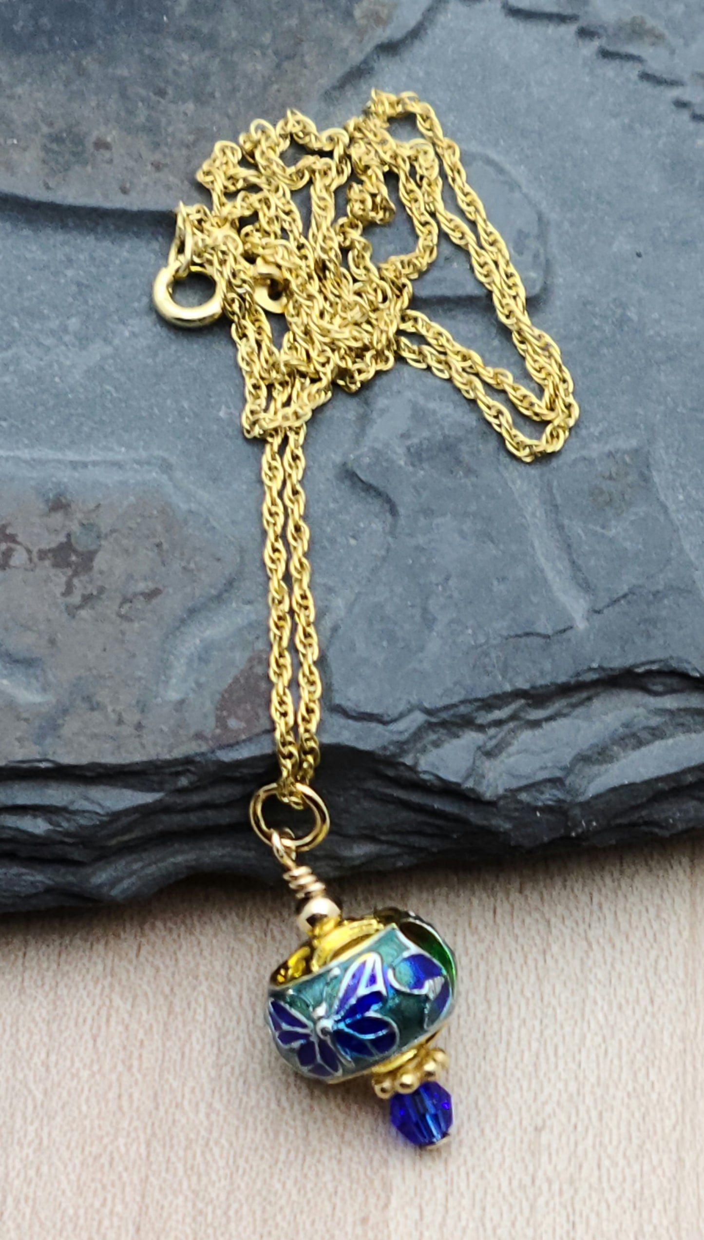 A sweet butterfly graces this petite cloisonné bead & the blue is accented by a deep blue crystal & gold filled findings to create a look of elegance.
on a 16" chain