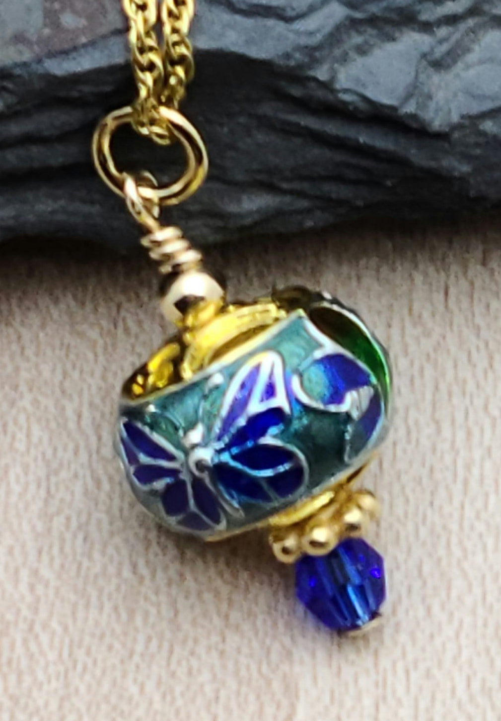 A sweet butterfly graces this petite cloisonné bead & the blue is accented by a deep blue crystal & gold filled findings to create a look of elegance.