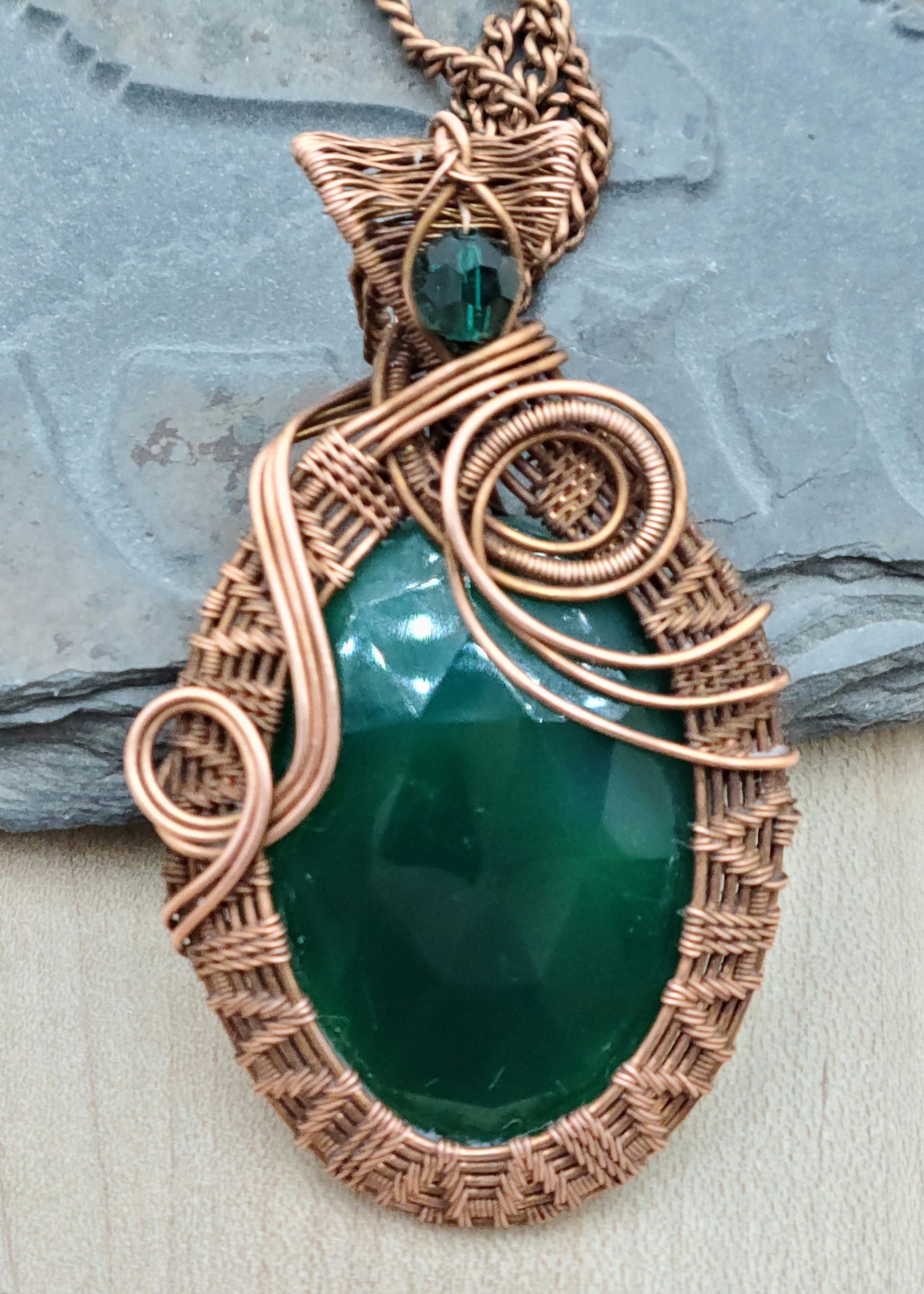 Meet your new emotional wellness companion—a stunning faceted large green onyx stone cradled in vintage antiqued copper wire and accented with an emerald crystal!