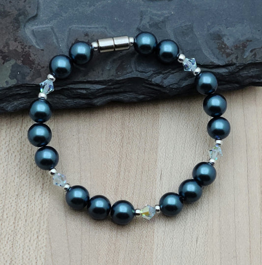Electroplated magnetic hematite in a rich teal pairs beautifully with aurora borealis azure blue crystals! 7 1/4" Bracelet with wonderful neodymium magnetic clasp.