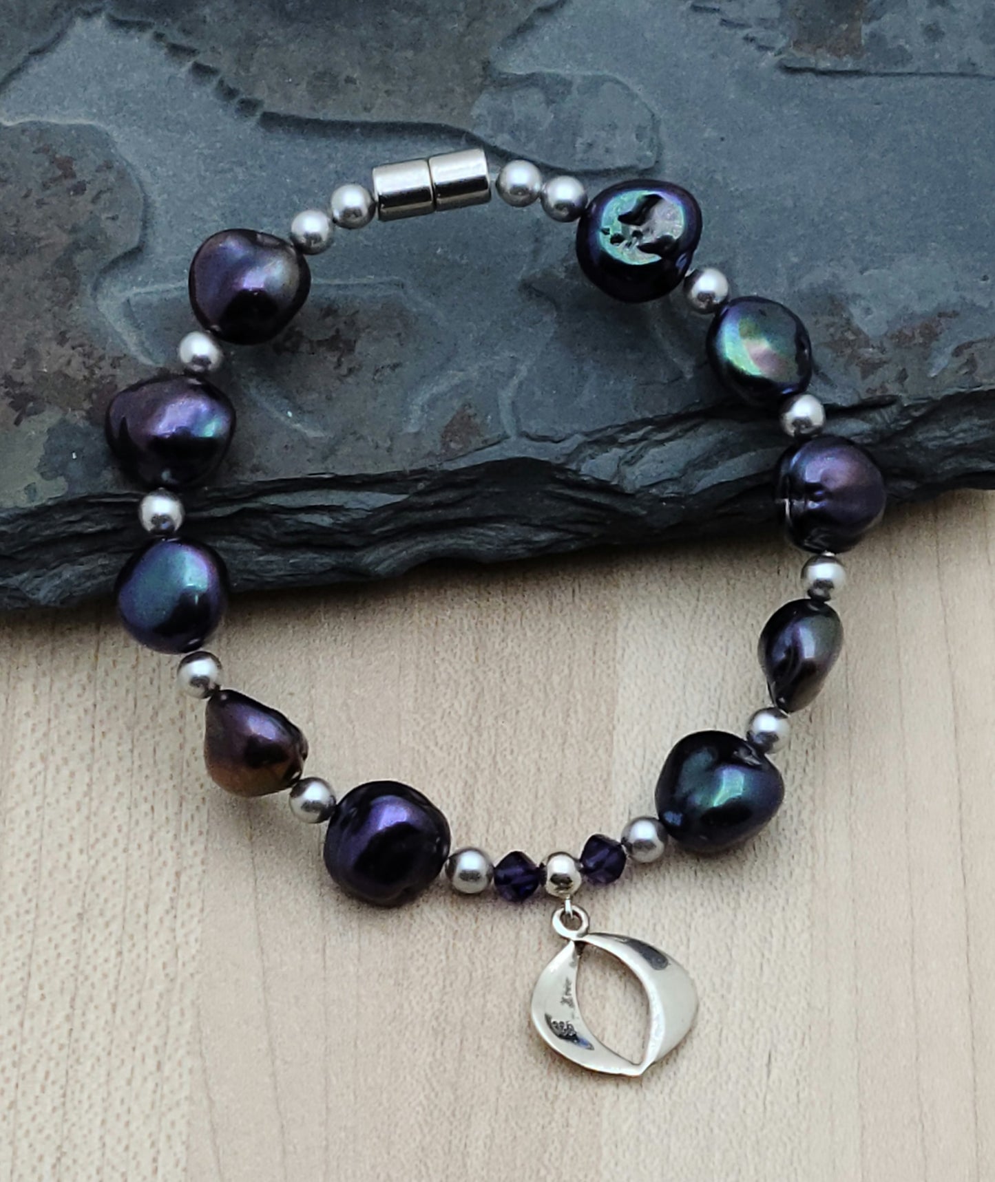 These Keshi pearls are a luscious blend of dark purple, teal, green, and a hint of black. Gorgeous! Magnetic clasp.