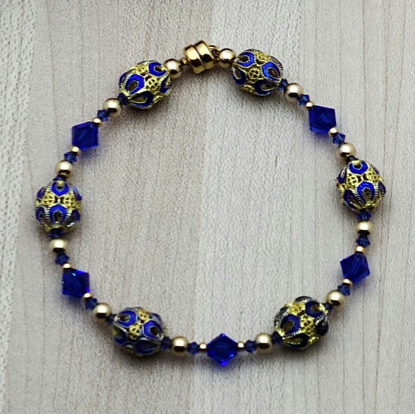The deep, bright blue & gold of these filigree cloisonné beads & the rich blue of the crystals are definitely gorgeous!