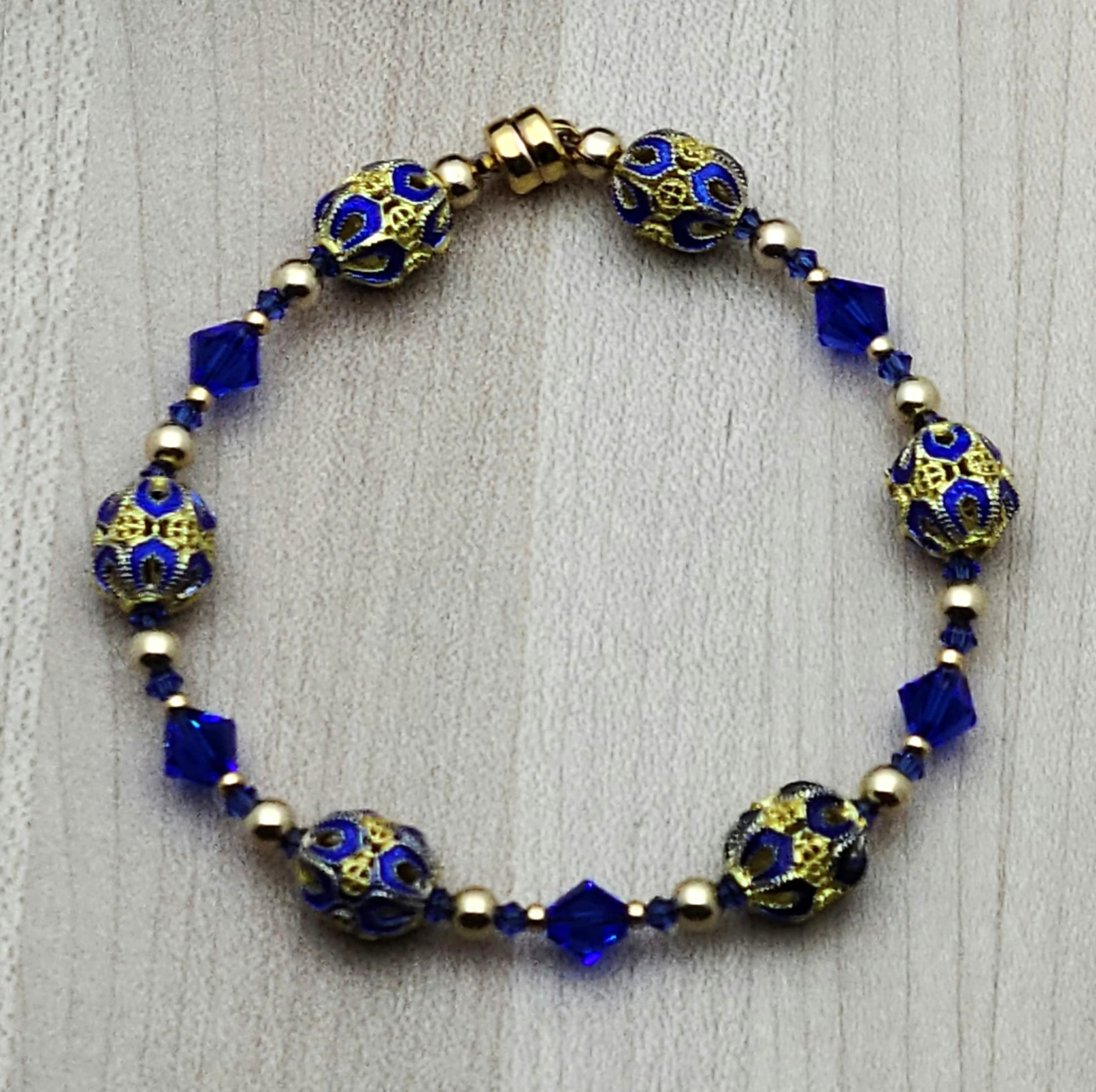 The deep, bright blue & gold of these filigree cloisonné beads & the rich blue of the crystals are definitely gorgeous!