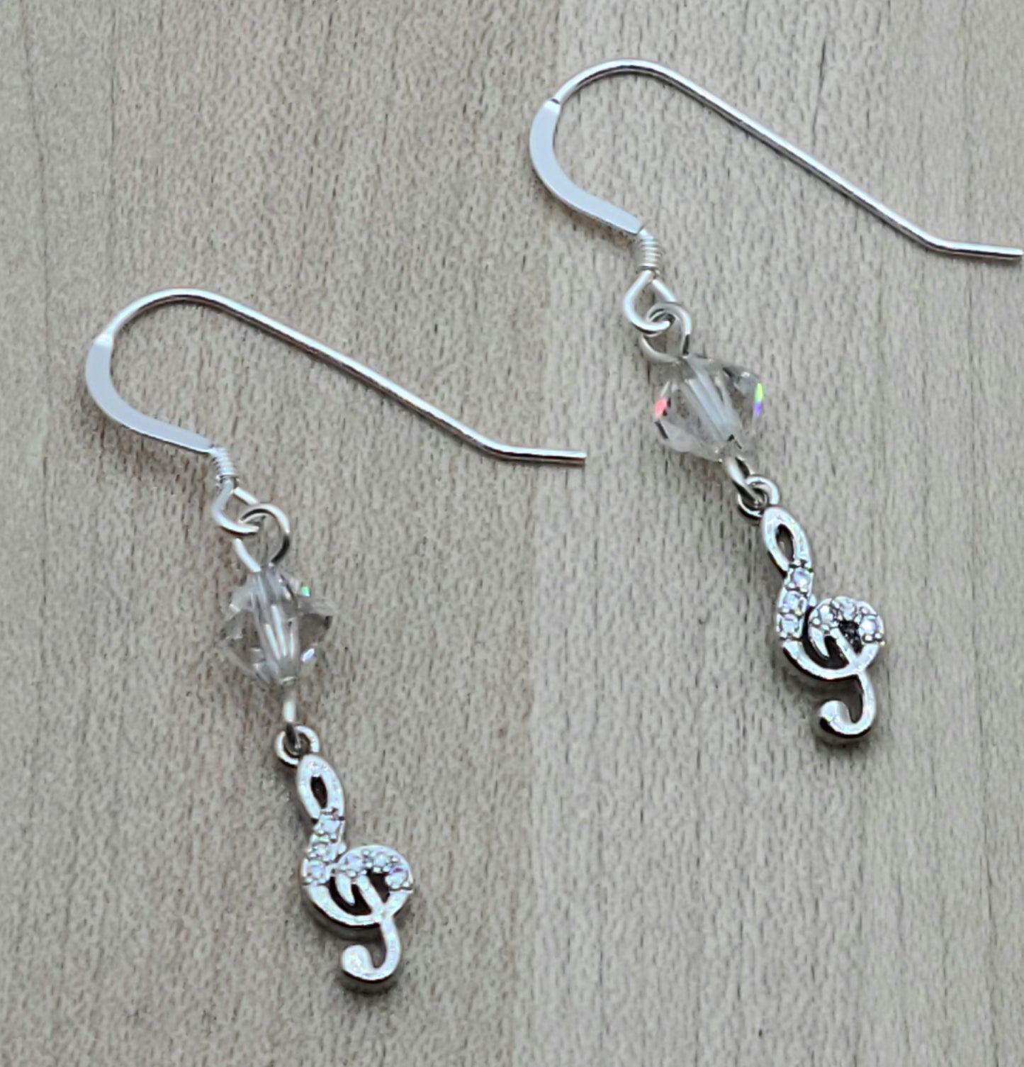 Sparkle with your love of music! Sterling silver &amp; cubic zirconia treble clefs catch the light, as do the crystals* from which they are suspended!