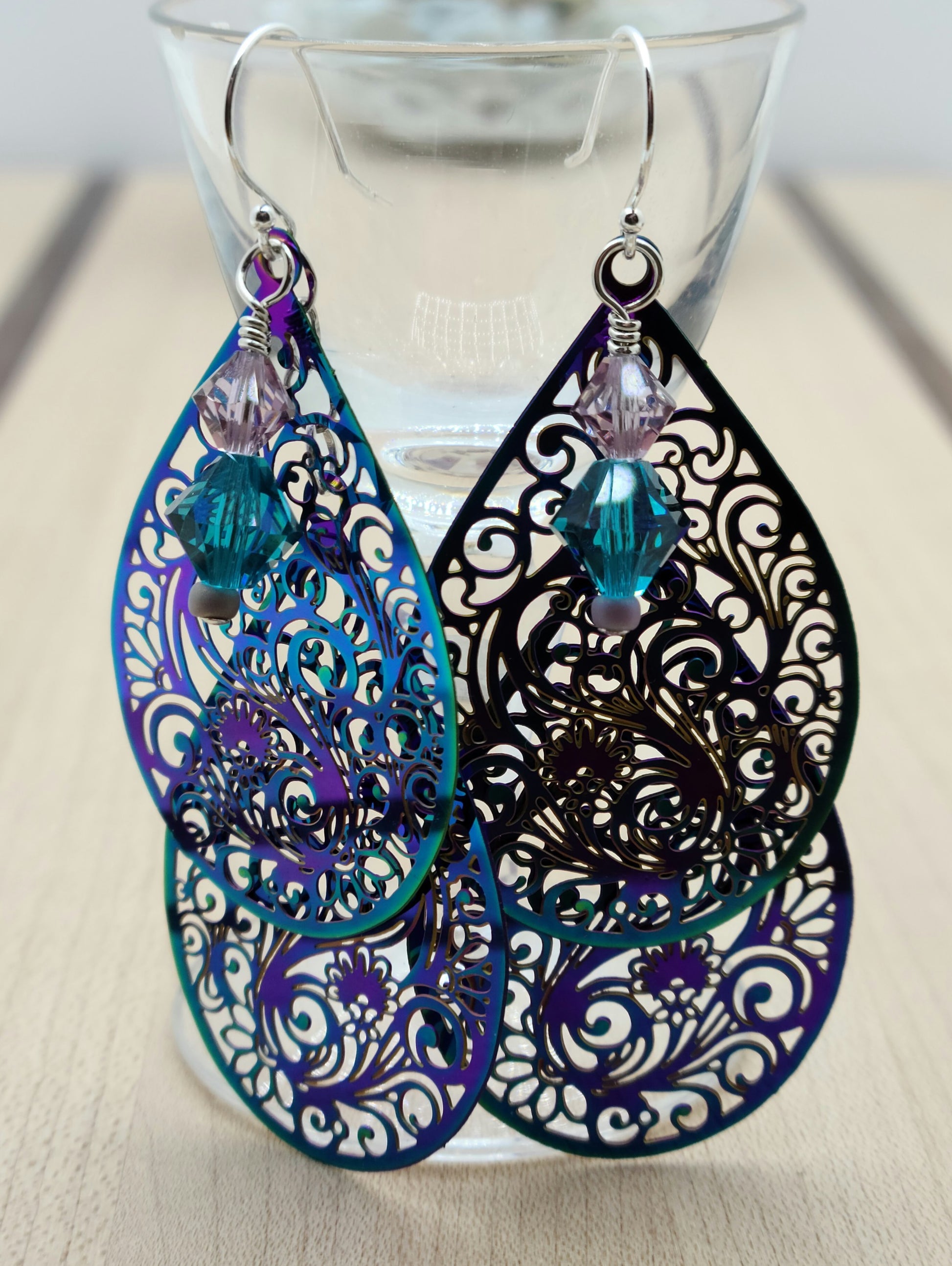 These incredibly lightweight electroplated teal & purple stainless steel teardrops have been laser cut with a swirling and intricate design. I added crystal ornaments for a 'bling' element.