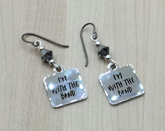 Proudly announce that you are indeed "with the band" by wearing these shiny stainless steel earrings suspended from chrome crystals.