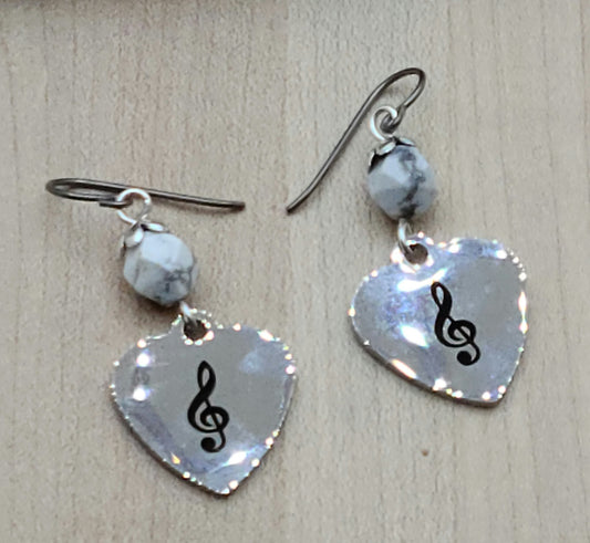 Love music? Play a treble clef instrument? Then these stainless steel hearts displaying a treble clef are for you! For added interest they hang from capped, faceted howlite beads.