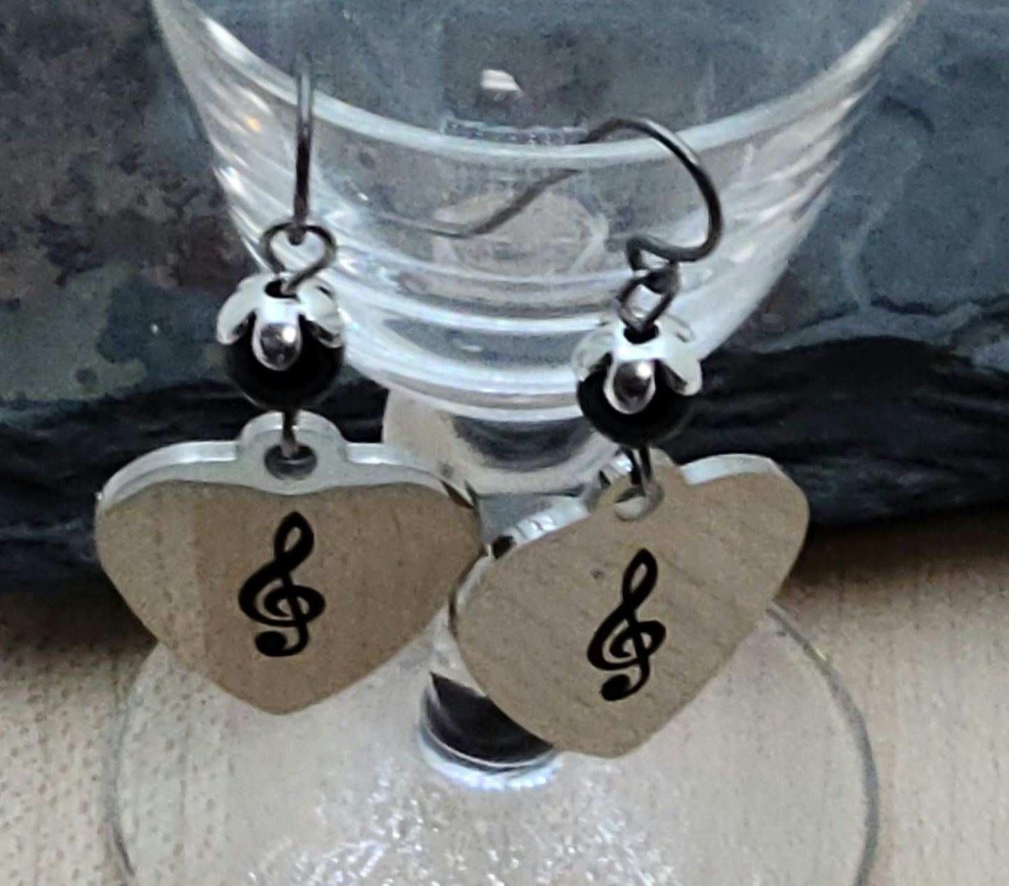 Love music? Play a treble clef instrument? Then these stainless steel hearts displaying a treble clef are for you! For added interest they hang from capped black crystal pearls.
1 3/4" with niobium (considered hypoallergenic) fish hook earwires