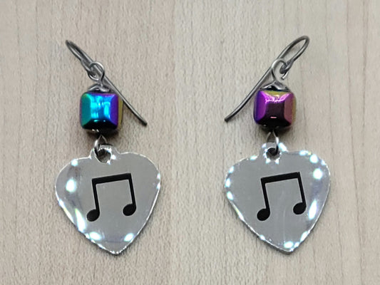 Love music? Play a group? Then these stainless steel hearts displaying 8th notes are for you! For added interest they hang from hematite beads electroplated in rainbow colors!
1 3/4" with niobium (considered hypoallergenic) fish hook earwires