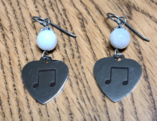 Love music? Play a group? Then these stainless steel hearts displaying 8th notes are for you! For added interest they hang from white lace agate beads.
1 3/4" with niobium (considered hypoallergenic) fish hook earwires