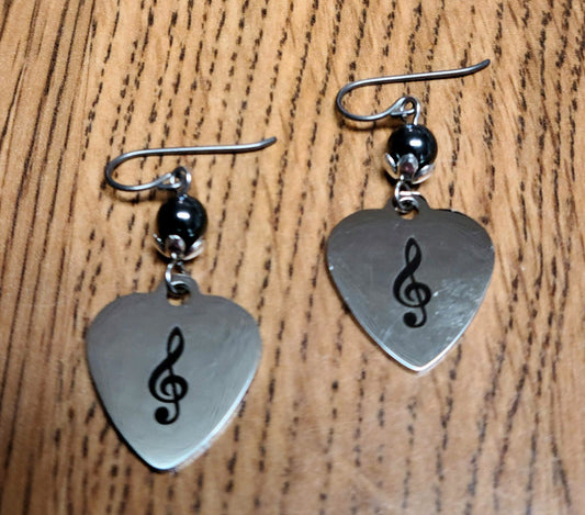 Love music? Play a treble clef instrument? Then these stainless steel hearts displaying a treble clef are for you! For added interest they hang from capped, shiny dark grey hematite beads.
1 3/4" with niobium (considered hypoallergenic) fish hook earwires