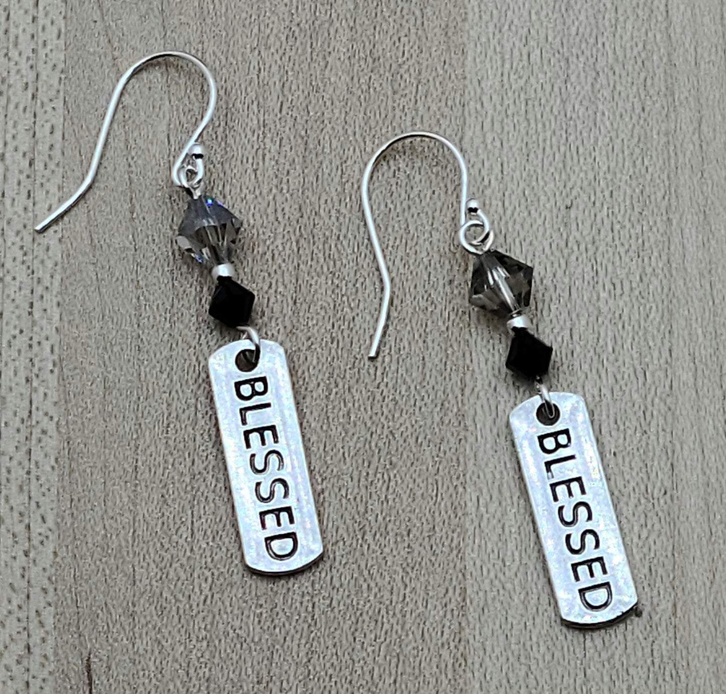 Feeling blessed? I certainly do! These pewter earrings stamped with BLESSED and suspended from blingy crystals let folks know how you feel.
2" with sterling silver fish hook earwires