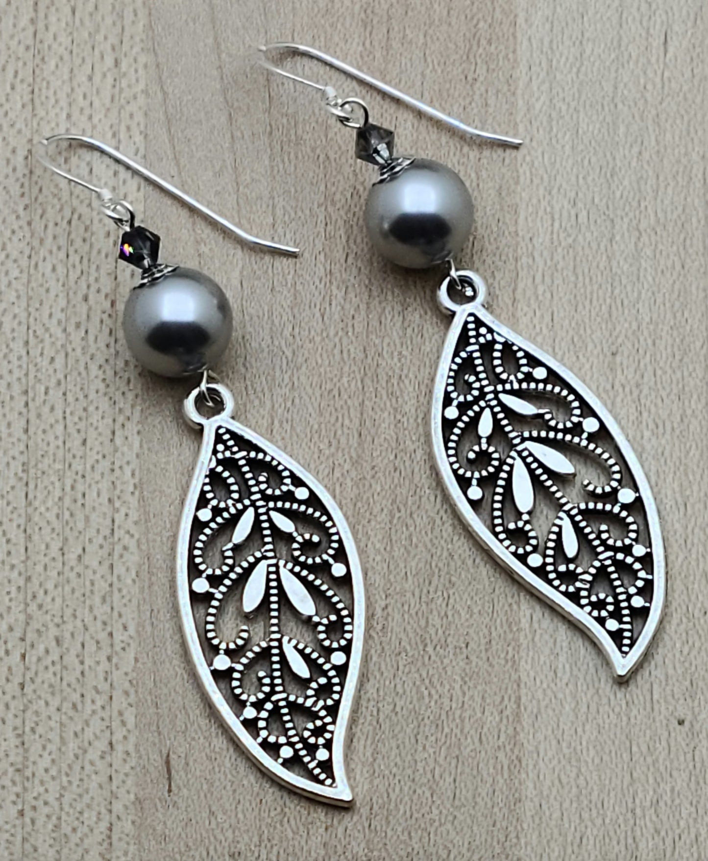 Intricate open work leaves in pewter and lustrous silver crystals & crystal pearls combine for elegant & fancy earrings that will complement any outfit!