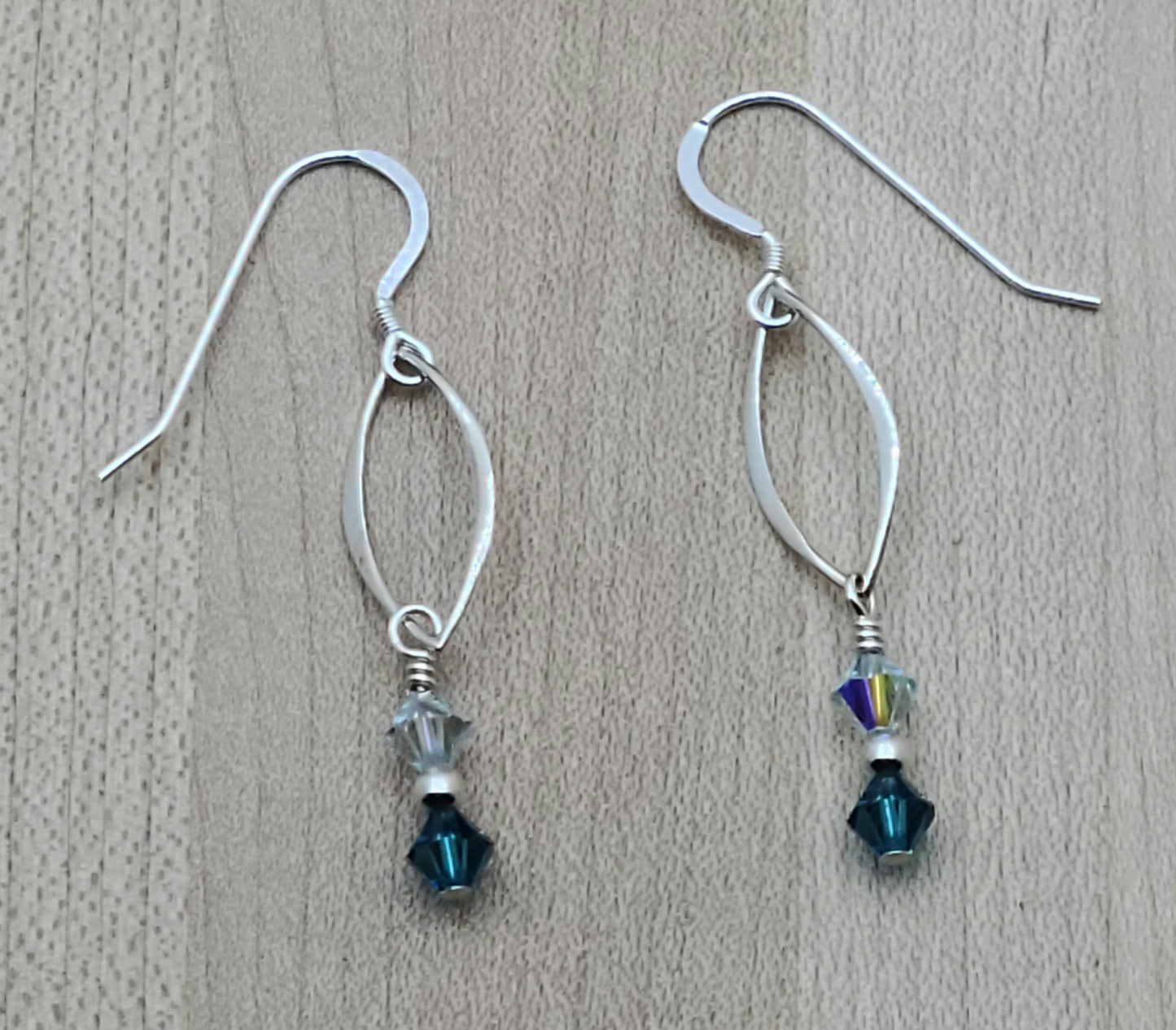 Understated elegance in sterling silver & shades of azure crystal that will capture attention with lots of movement! 2" with sterling silver fish hook earwires