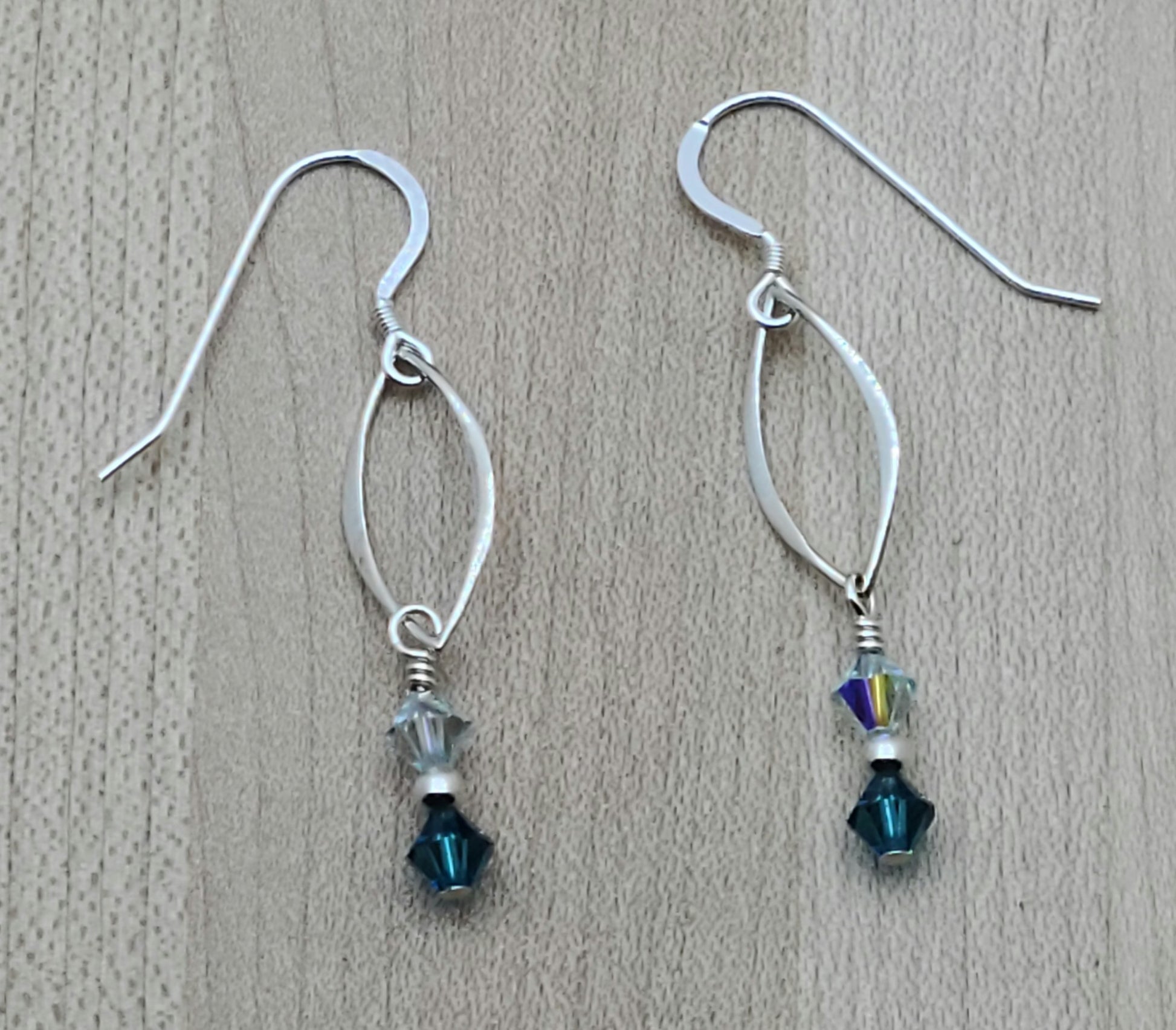Understated elegance in sterling silver & shades of azure crystal that will capture attention with lots of movement! 2" with sterling silver fish hook earwires