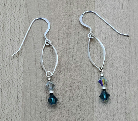 Understated elegance in sterling silver & shades of azure crystal that will capture attention with lots of movement! 2" with sterling silver fish hook earwires
