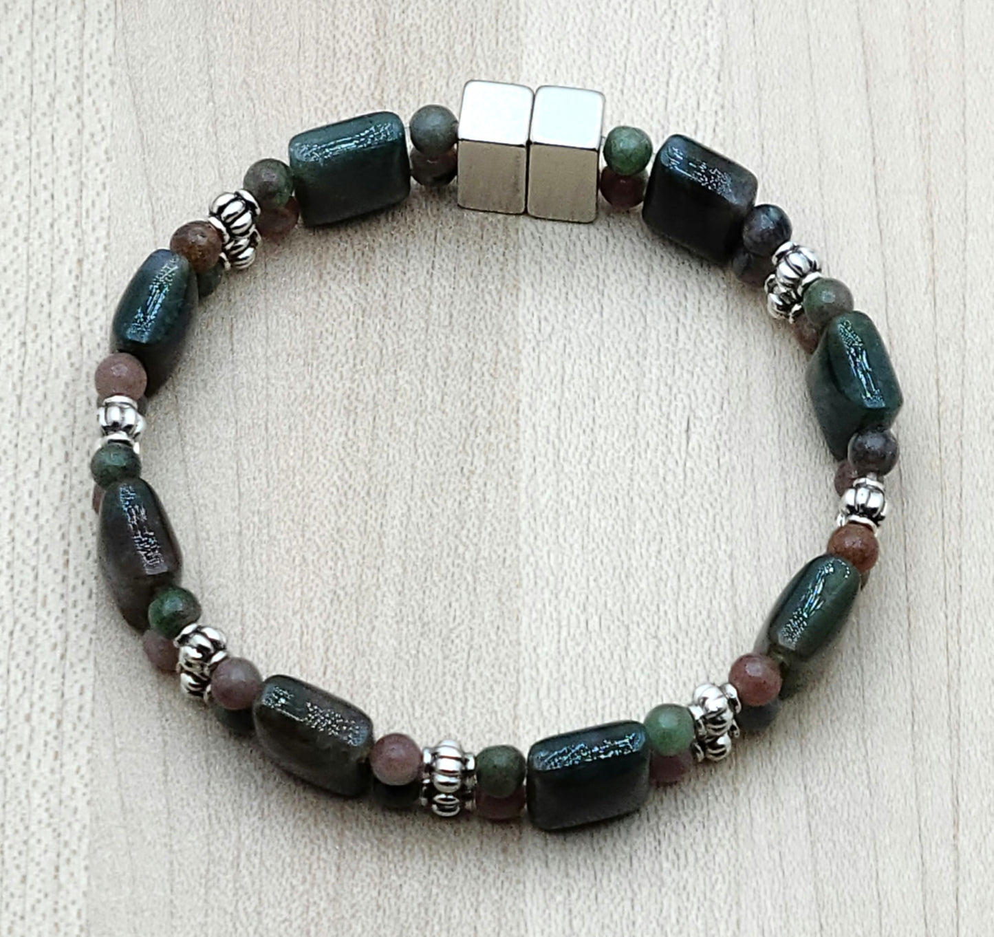 If you're a fan of green & all things earthy, this bracelet is for you! The deep green of the moss agate squares finds a great companion in the muted greens &  roses of Kashgar garnet. Bali style silver pewter beads add just enough brightness.
Neodymium magnetic clasp - these are awesome . . . & VERY strong!